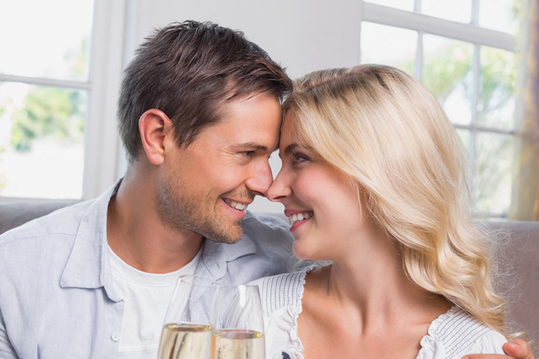 Loving couple with champagne flutes at home - Photo, image