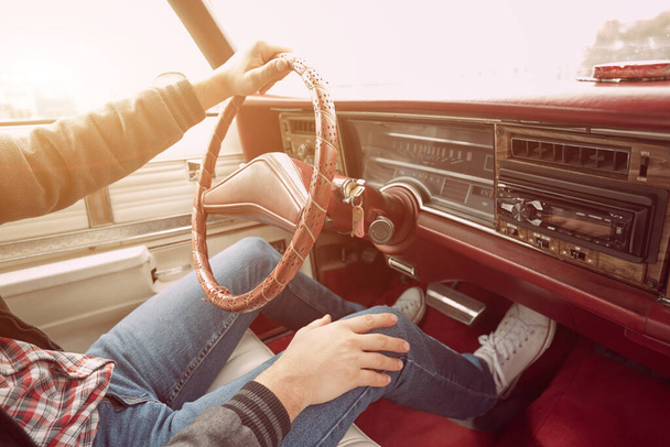 Man in retro clothes driving vintage American car. - Фото, изображение