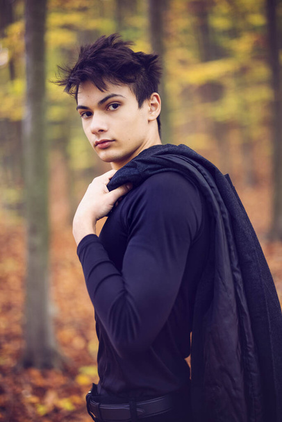 Portrait with a handsome young man in autumn forest, fashion concept. - Photo, Image