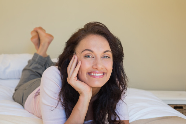 Happy woman lying in bed - Photo, Image