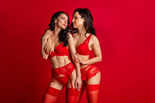 Portrait of two nice-looking attractive lovable stunning glamorous luxury chic hot seductive tempting nude naked girls embracing romantic isolated bright vivid shine vibrant red color background - Φωτογραφία, εικόνα