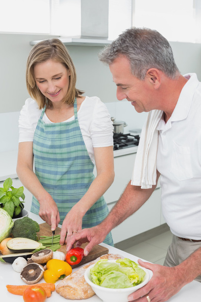 Happy couple preparing food together in kitchen - Photo, Image