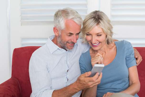 Smiling mature couple reading text message - Foto, Bild