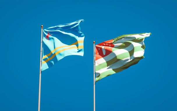 Prachtige nationale staatsvlaggen van Abchazië en Aruba samen op de achtergrond. 3D-kunstwerkconcept. - Foto, afbeelding