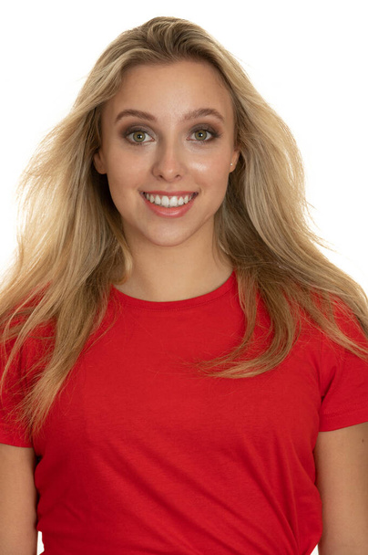 Portrait of a cute teenage girl in red tshirt over white - Fotó, kép