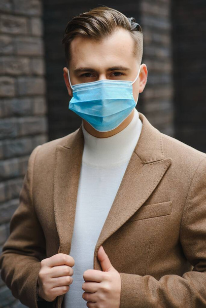 Businessman with a breathing mask isolated in office space - Foto, afbeelding