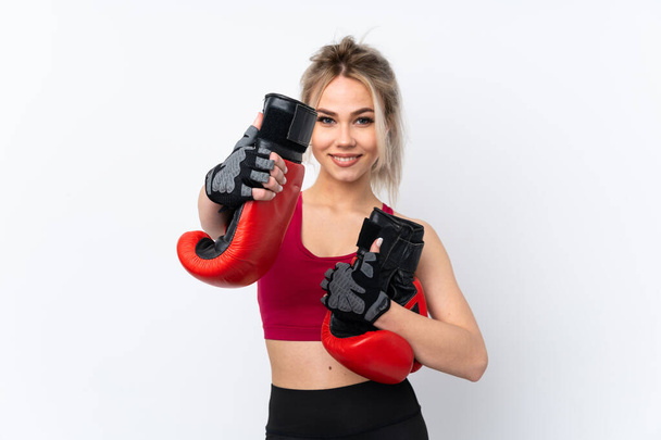 Teenager girl holding waffles over isolated blue background with boxing gloves - Фото, зображення