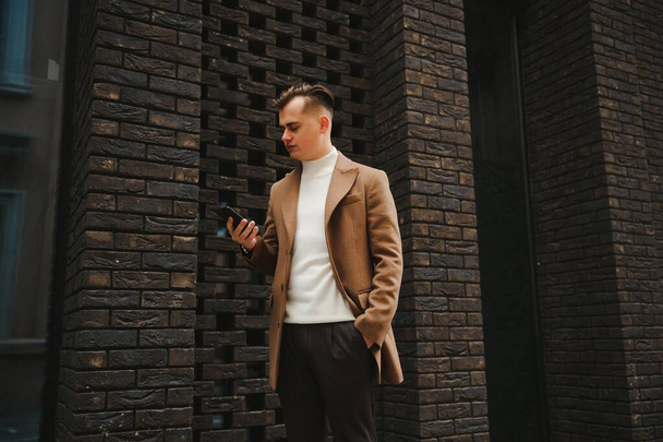 Stylish elegant men man in coat in urban style - Фото, зображення