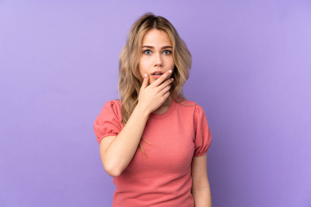 Teenager Russian girl isolated on purple background surprised and shocked while looking right - Photo, image