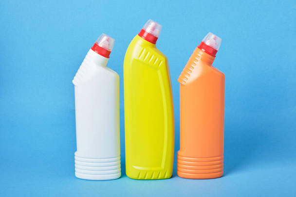 detergent bottles, detergents for toilet bowls on a blue background. copy space - 写真・画像