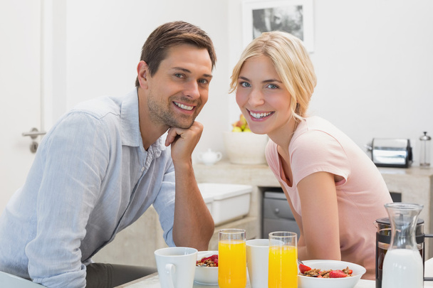 Young couple having breakfast at home - Fotó, kép