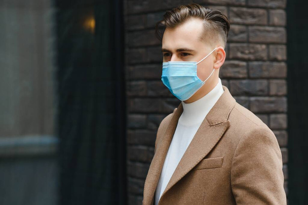 Businessman with a breathing mask isolated in office space - Foto, imagen