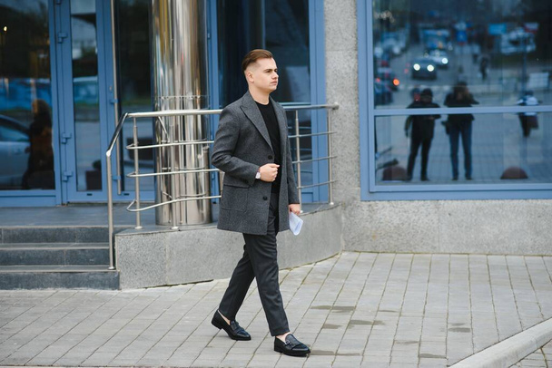 Stylish elegant men man in coat in urban style - Foto, afbeelding