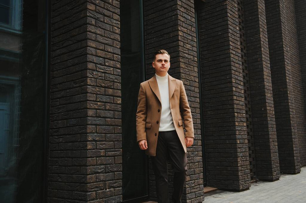Stylish elegant men man in coat in urban style - Фото, зображення