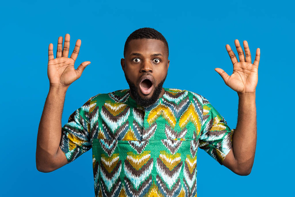 Shocked black guy with hands up and open mouth - Photo, Image