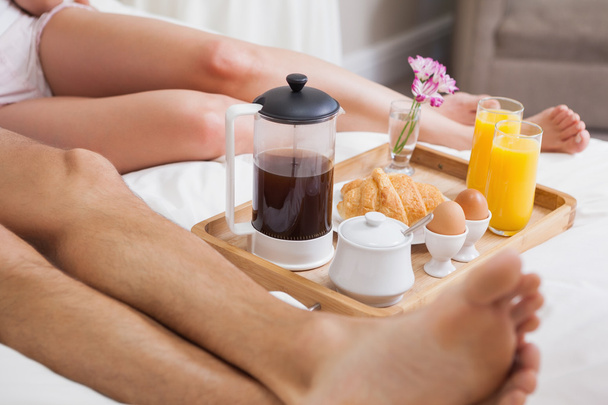 Low section of couple having breakfast in bed - Foto, immagini