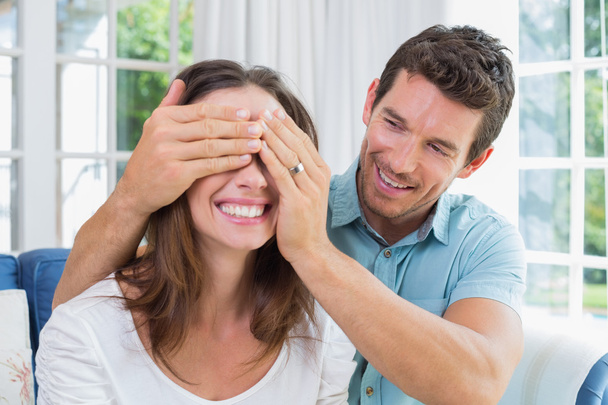 Close-up of a man surprising woman at home - Foto, imagen