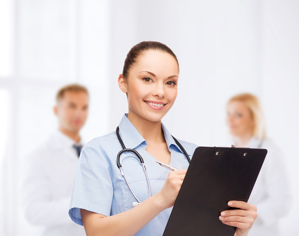Smiling female doctor or nurse with stethoscope - Valokuva, kuva