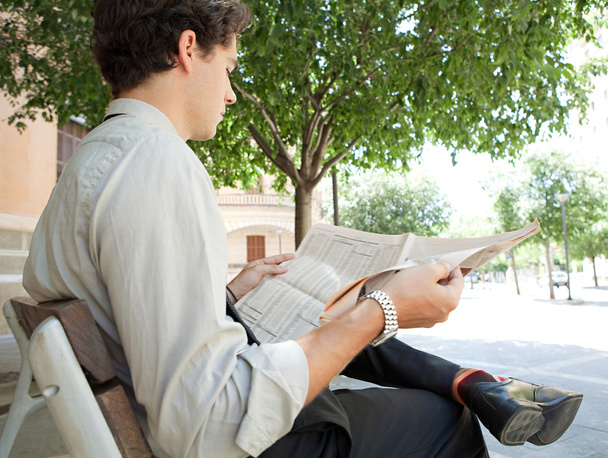 Businessman reading a financial newspaper - Photo, Image