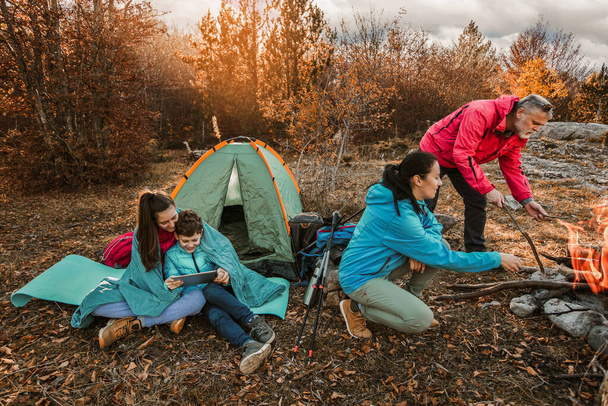 Familia feliz en un viaje de campamento. Familia haciendo camping en el bosque - Foto, Imagen