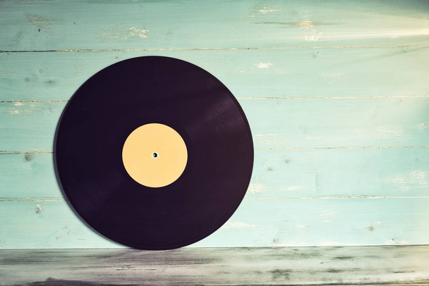 Vinyl record on wooden background,Old vintage vinyl record isolated - Foto, imagen