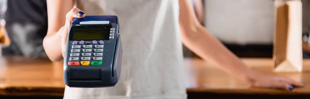 partial view of barista holding payment terminal, blurred background, banner - Photo, Image