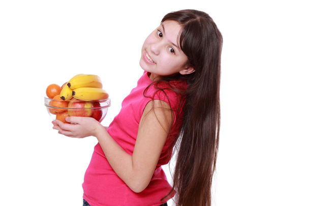 Girl holding fruit bowl - Valokuva, kuva