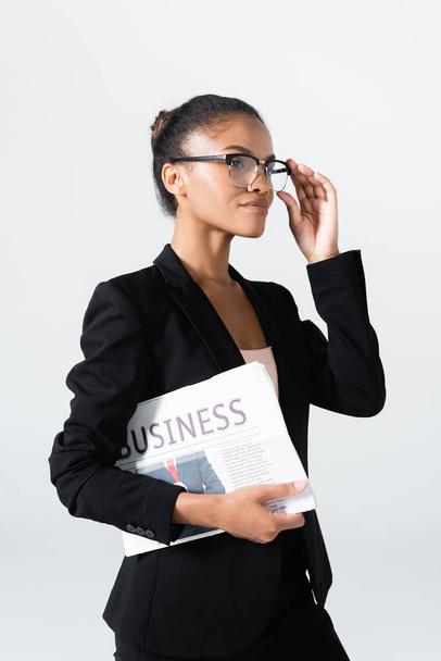 african american businesswoman in glasses with business newspaper isolated on grey - Photo, Image