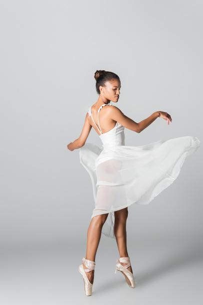 graceful african american ballerina in dress dancing on white background - Photo, Image