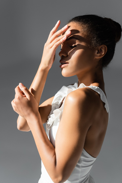 graceful african american ballerina in sunlight on white background - Photo, Image