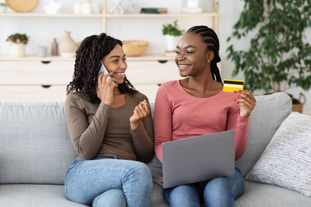 Black girlfriends ordering food online, making confirmation on phone - Фото, изображение