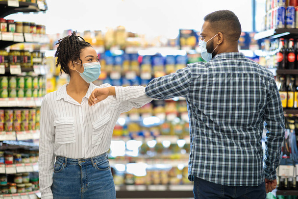 Lady In Mask Bumping Elbows With Guy In Grocery Store - Photo, Image