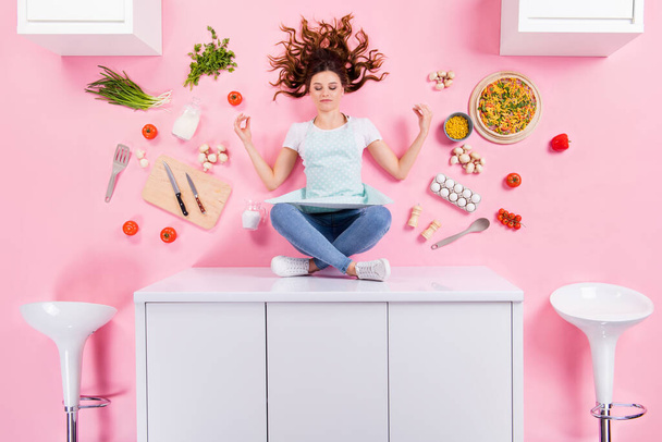 Top above high angle full size photo of focused pizzeria worker girl sit table mediate ready prepare tasty delicious pizza flat lay ingredients kitchenware isolated pastel color background - Photo, Image