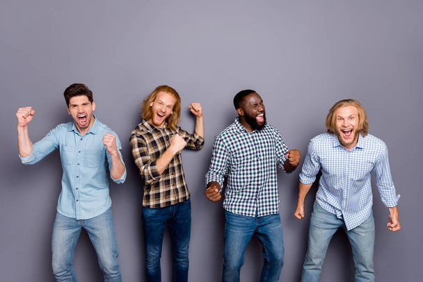 Portrait of four nice attractive lucky glad ecstatic overjoyed cheerful cheery guys celebrating great luck attainment isolated over gray purple pastel color background - Φωτογραφία, εικόνα