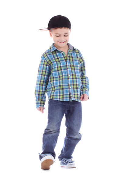 Smiling little boy in jeans and cup dancing hip-hop - 写真・画像