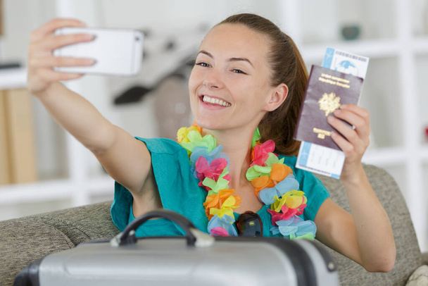 young happy woman making selfie photo with passport - Фото, изображение