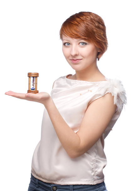 Attractive girl holding on her hand sand clock - Zdjęcie, obraz