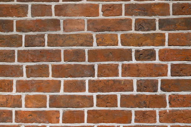 Texture of a red brick wall laid with white cement as a background - Foto, imagen