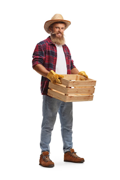 Bearded guy farmer with an empty wooden crate isolated on white background - Photo, image