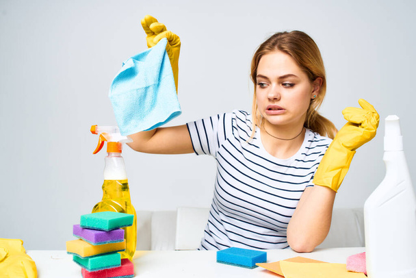 Woman holding a rag cleaning detergent supplies housework interior - Фото, зображення