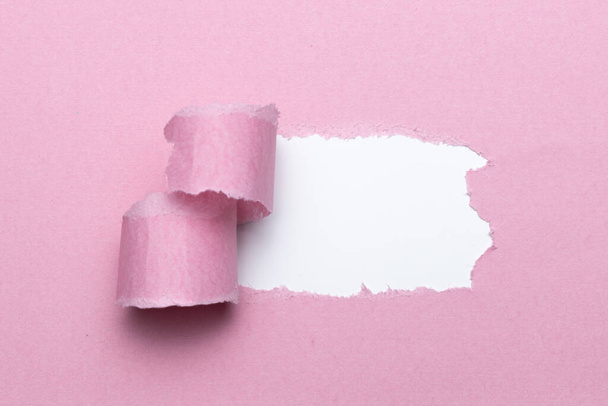 Breach or peeled of paper for hidden text used as template or mockup on pink natural paper, use for compositions and easy to color - Photo, Image