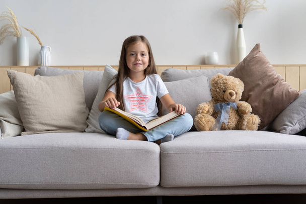 Young girl reading book at home. Distance education, home education. Self isolation concept. - Foto, Imagem