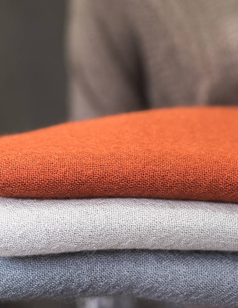pomarańczowy szary biały wełniany sweter, zbliżenie kolorowe tkaniny, stos kaszmirowych tekstyliów, stos kolorowych ubrań, stos ubrań - Zdjęcie, obraz