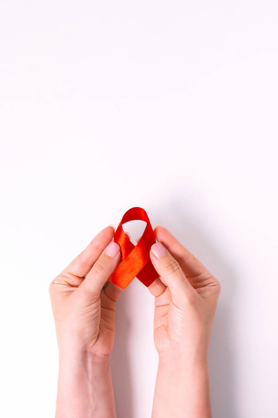 World AIDS day. Ribbon in womans hands. - Fotografie, Obrázek