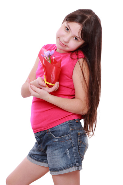 Girl holding spring flower in pot - Foto, imagen