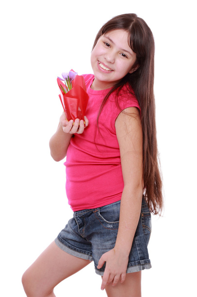 Pretty little girl holding spring flower in pot - Фото, зображення