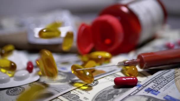 Color Capsules Fall on Dollar Bills and Syringe with Blood. Expensive Medicines - Footage, Video