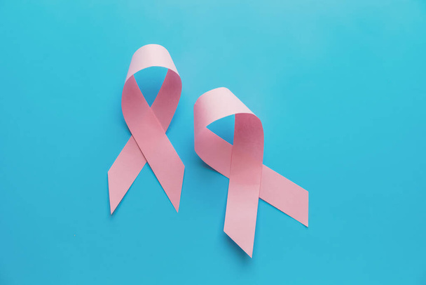 Pink ribbons on color background. Breast cancer awareness concept - Fotó, kép