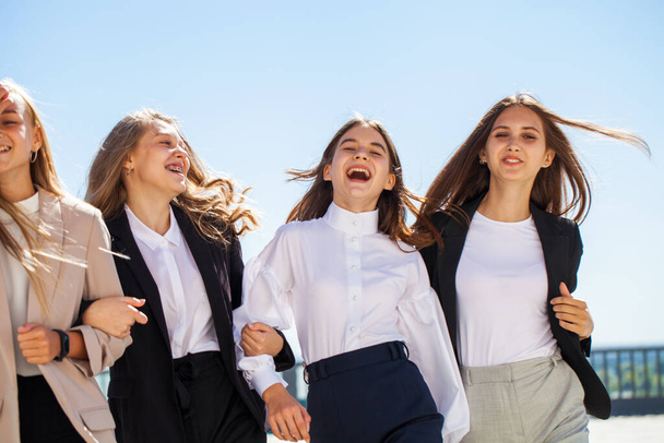 Four cheerful girlfriends in school uniform - Foto, immagini