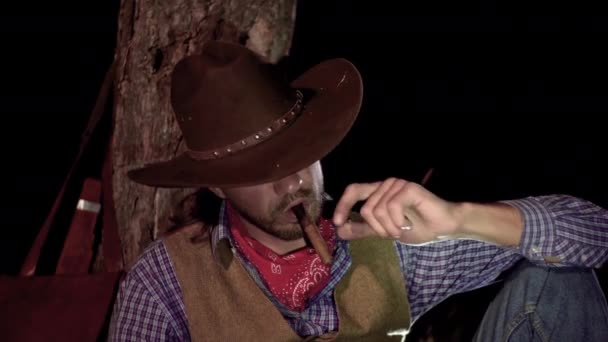 Cowboy with a cigar in the forest at night - Footage, Video